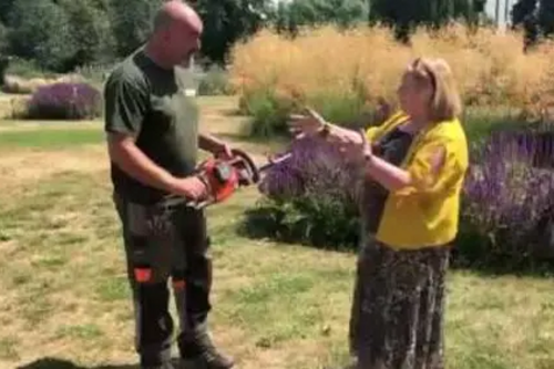 Cllr. Jude Deakin and council staff use electric equipment in parks.