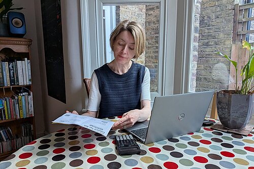 Lib Dem campaigner Naomi McCarthy examining a recent Council Tax bill