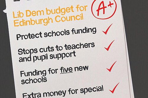 A sheet of paper reading "Lib Dem budget for Edinburgh Council  - Protects schools funding - Stops cuts to teachers and pupil support - Funding for five new schools - Extra money for special schools"