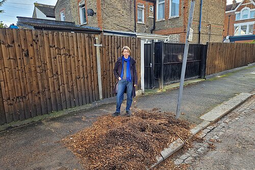 Naomi McCarthy next to a removed street tree