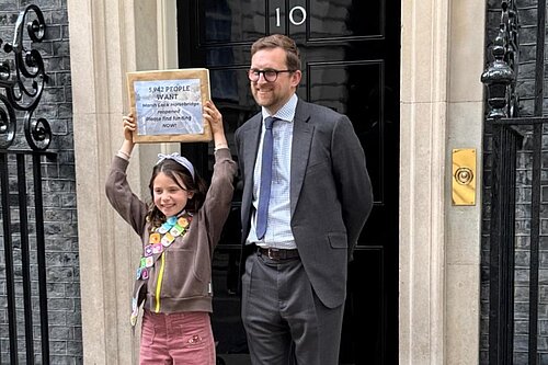 Freddie with campaigner Claudia and her petition outside 10 Downing Street