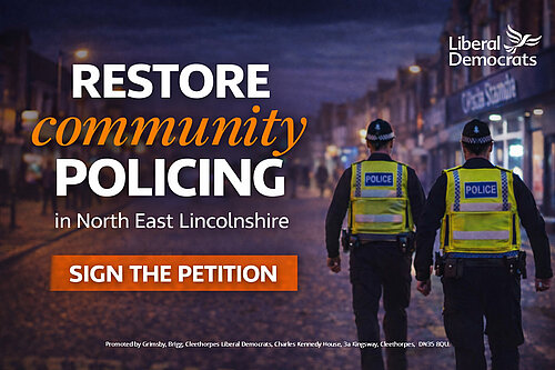Two police officers walking on patrol in a town centre street at dusk, with text reading “Restore community policing in North East Lincolnshire” and “Sign the petition”.