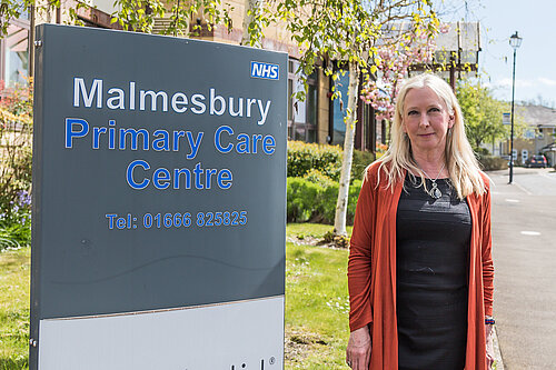 Roz Savage MP standing outside a dentist's.