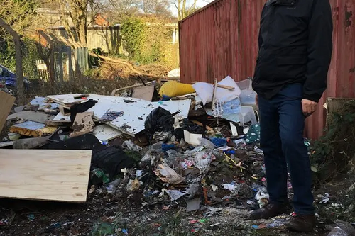 Councillor Roger Harmer looking at dumped rubbish in Acocks Green
