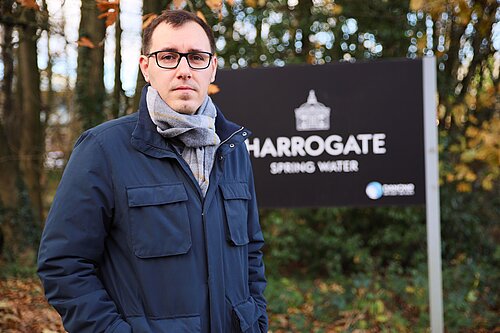 Tom Gordon stood by a Harrogate Spring Water sign