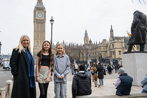 Roz Savage MP with aspiring young reports in front of Big Ben, London