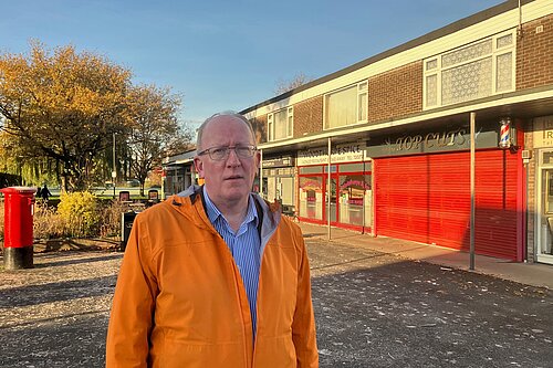 Cllr Stephen Fenton at the car park entrance and in front of the shops.