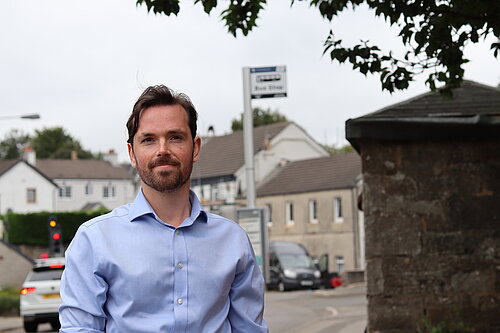 Adam Harley in Torrance with a bus stop in the background.