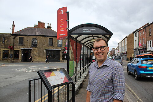 Tom at bus stop