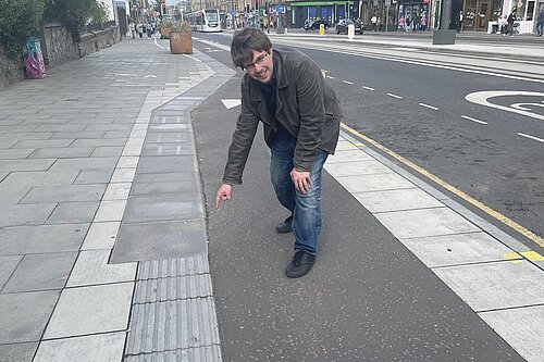 Jack Caldwell pointing at tactile pavements