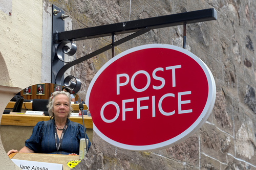 Cllr Jane Ainslie in front of post office sign