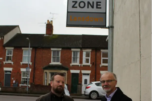 Councillors Toby Robson and Stan Pajak standing next to the 20 mph sign in Lansdown Road, Swindon