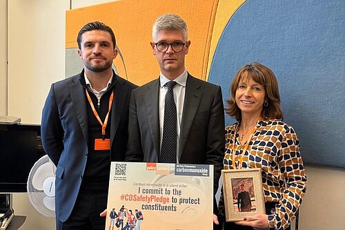 MP standing with constituent at drop-in