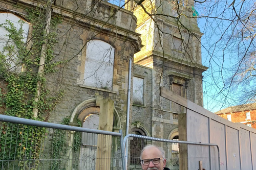 Councillor Stan Pajak standing next to the Locarno building