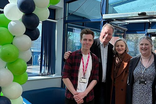Cllrs Nathan Hunt, Tom Sanderson, Ann Blackwell, and Sally Howell under a balloon arch