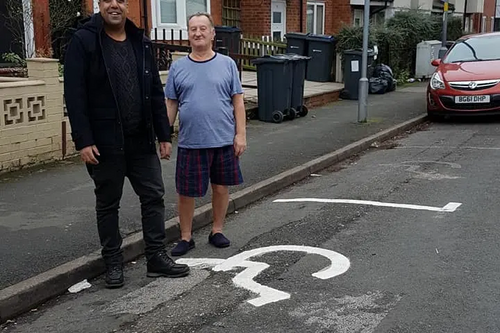 Liberal Democrat campaigner Baber Baz with a local resident
