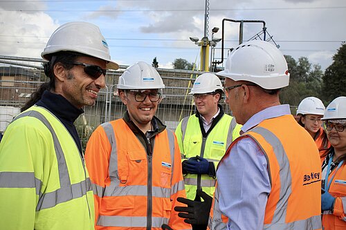 Tom Gordon speaking with workers at the water sewage treatment plant