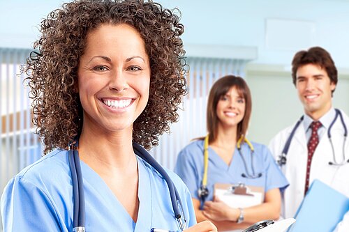 Three doctors smiling.
