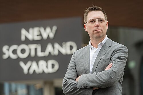 Photo of Rob Blackie in front of New Scotland Yard