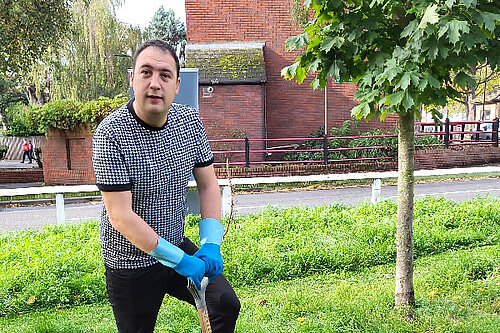 Cllr Gary Busuttil planting a tree.