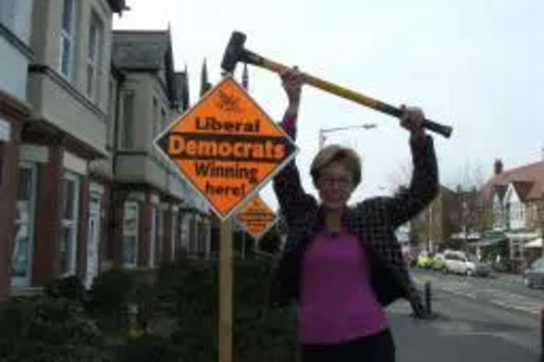 Lynne Beaumont with "Winning Here" garden poster