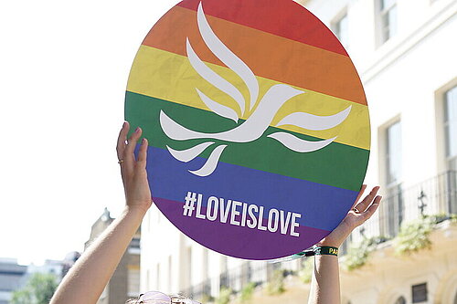 Lib Dem sign with a rainbow and the words Love is Love underneath the Lib Dem bird