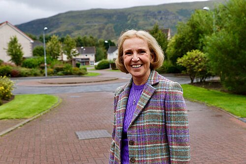 Susan Murray stands Infront of the Campsie Fells