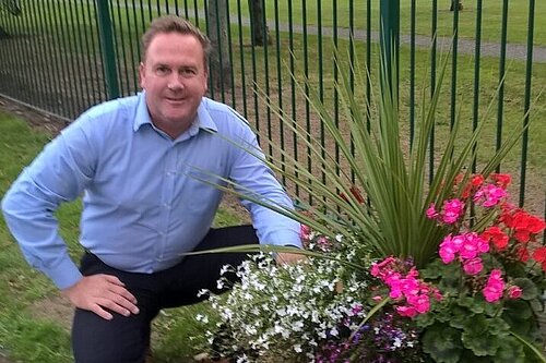 Chris Jones and flower planters in his Council Ward of West Dyke.