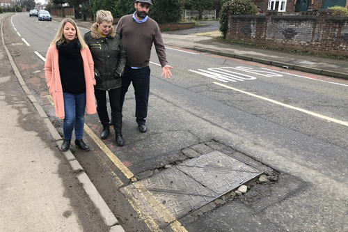 Sarah Sawyer, Linda Castle and Ian Williams at one of the manhole covers on Cheltenham Road