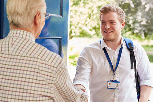 Social worker talking to an elderly man