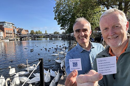 Mark Wilson and Ric Casales smiling near the River Thames