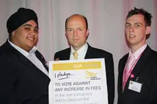 Robin Lawrence signs the Tuition Fee Pledge with Bally Singh Student Union President and Matt Ward Welfare VP