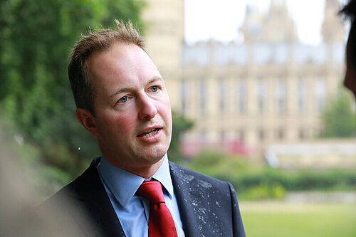 Richard Foord standing in front of Parliament