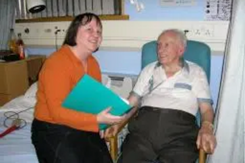 Jacquie with elderly patient in hospital