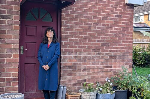 Manuela outside of a house