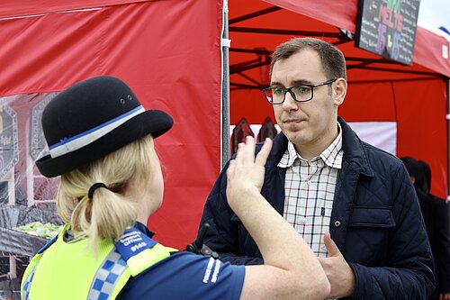 Tom Gordon speaking to a police office in Harrogate and Knaresborough