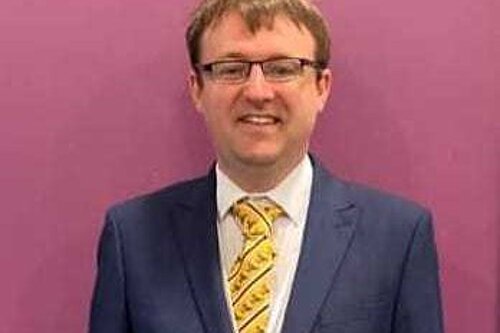 Person in front of purple background