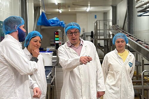 Tom Gordon pointing and asking a question to staff at Kirsty's