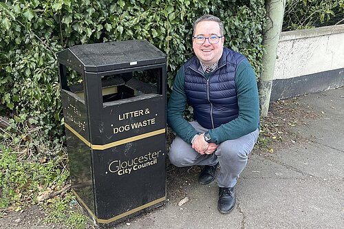 Councillor Field with one of the two new litter bins at the Stroud Road entrance to the ash path