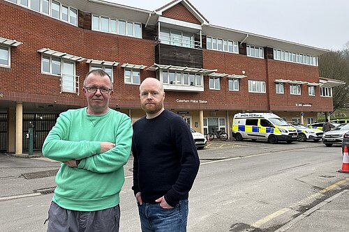 two men outside caterham police station