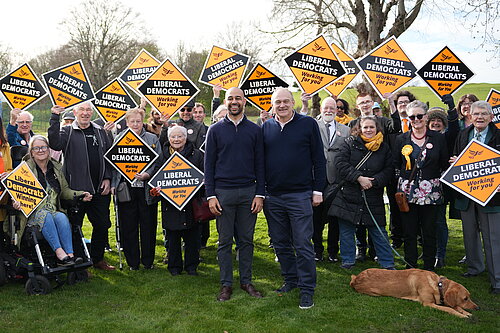 Josh Babarinde MP and Ed Davey MP with a crowd of activists in Eastbourne