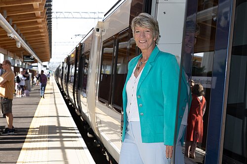 Pippa standing in the doorway of a train