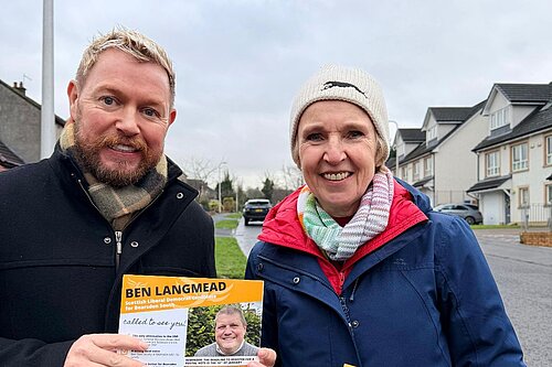 Jamie Greene and Susan Murray out campaigning holding canvass cards.