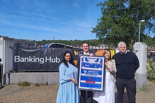 Outside the new banking hub, Jane Dodds MS, David Chadwick MP, Ams from the Temple Fish Bar and Steve from LINK holding up an Ystradgynlais rugby shirt