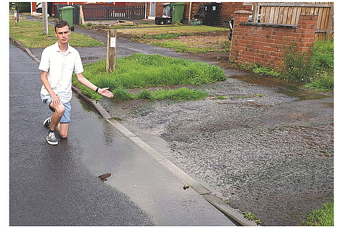 Campaigner Caleb Pell at the location where gallons of water are pouring on to the road in Tuke Avenue