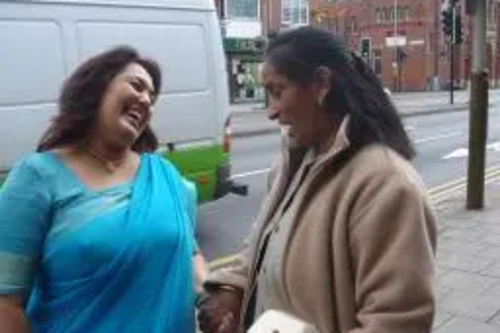 Josh Ramji (left) speaking to residents on Melton Road.