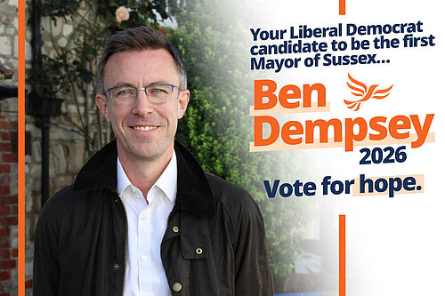 Portrait of Ben Dempsey, with glasses and well cut slightly greying hair, wearing an open necked white shirt and black jacket. Text: Your Liberal Democrat candidate to be the first mayor of Sussex. Ben Dempsey 2026. Vote for hope.
