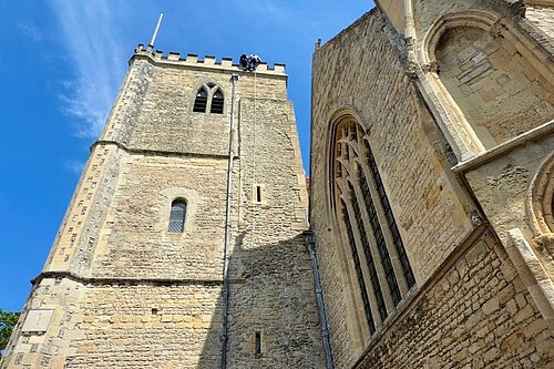 Freddie abseiling down Dorchester Abbey tower