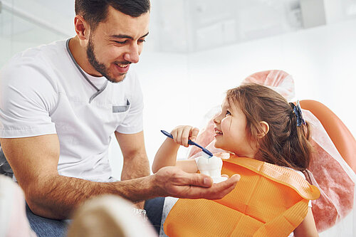 Dentists with child patient