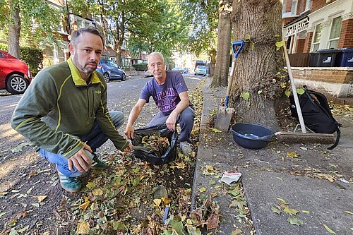 Councillor Gary Malcolm cleaning the streets with local resident John Eklof.